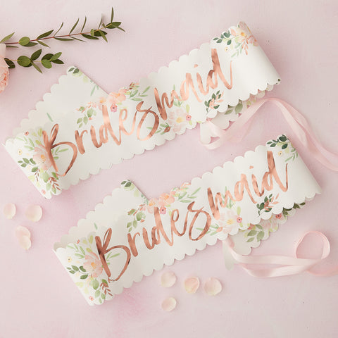 Floral Bridesmaid sash, with rose gold foiling , floral design and scalloped edges ties with a pink ribbon. Sash is made from paper. Would suit floral, Rose Gold, or botanical themed bridal shower or hen party decor