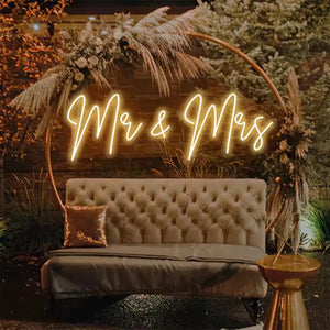The image displays a "Mr & Mrs" neon sign, commonly used for events like weddings and anniversaries. 
