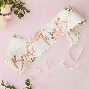 Floral Bride to be sash, with rose gold foiling , floral design and scalloped edges ties with a pink ribbon. Sash is made from paper